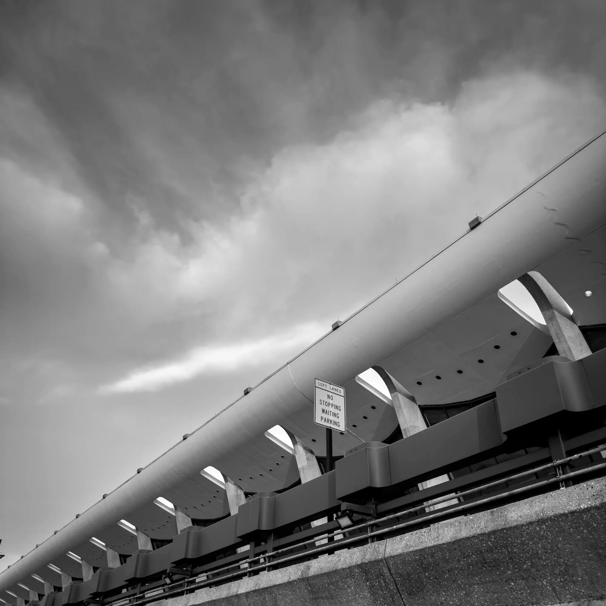 Monochromatic digital photograph of the main terminal at Dulles International Airport in Virginia. 